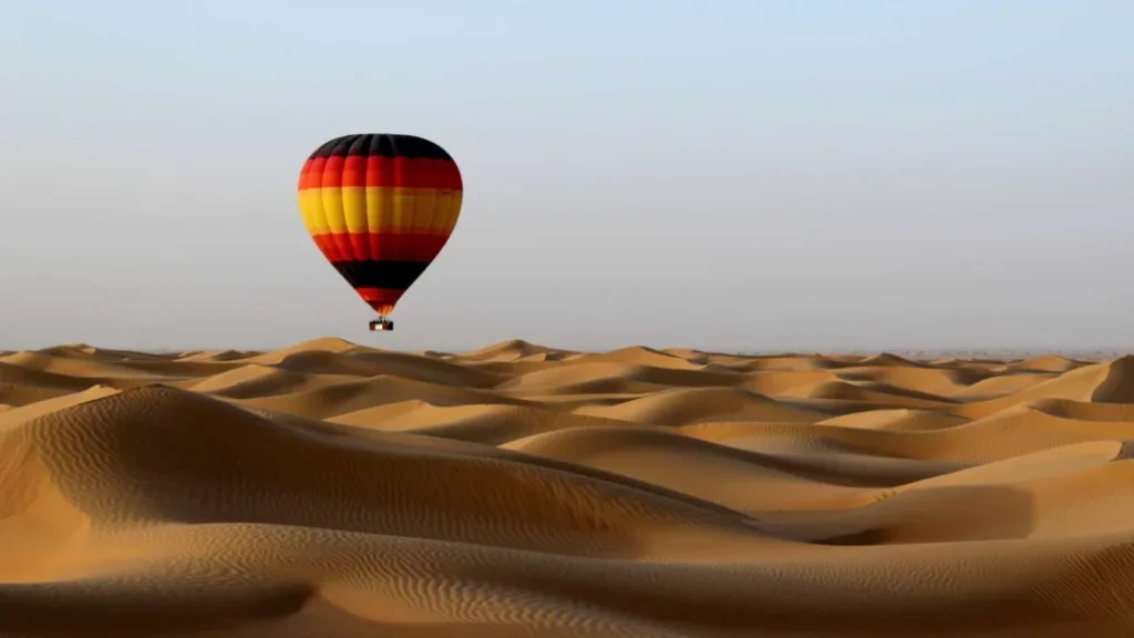 Stunning Dubai desert view with golden sand dunes, clear skies, and a breathtaking sunset landscape