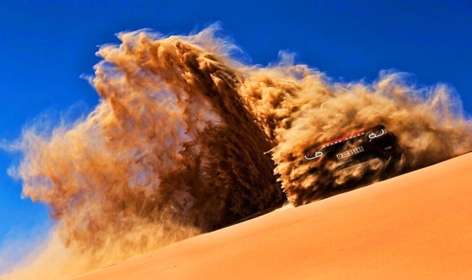 Tourists enjoying desert safari in Dubai with dune bashing ride