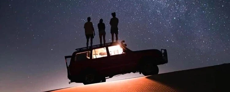 Sunday night Dubai desert safari with red dunes, camel ride, and camp lights