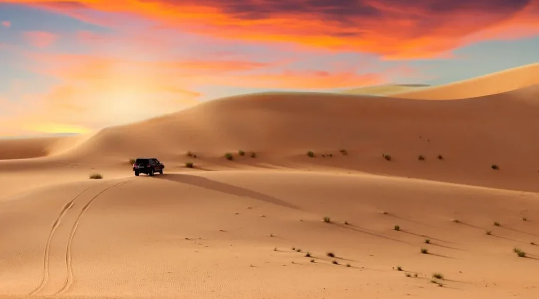 4×4 cresting red dunes at golden hour during a desert safari tour in Dubai