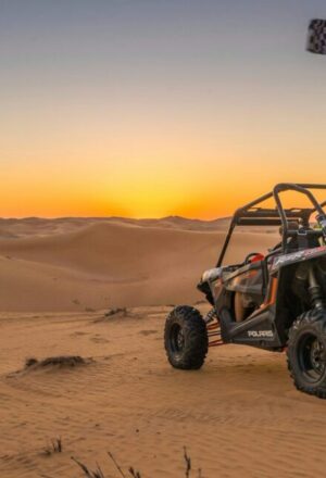 Dubai Dune Buggy Tours: Off-Road Thrills & Easy Booking › Forever Tourism LLC Dubai dune buggy tours with two-seater buggy driving over desert dunes at sunset