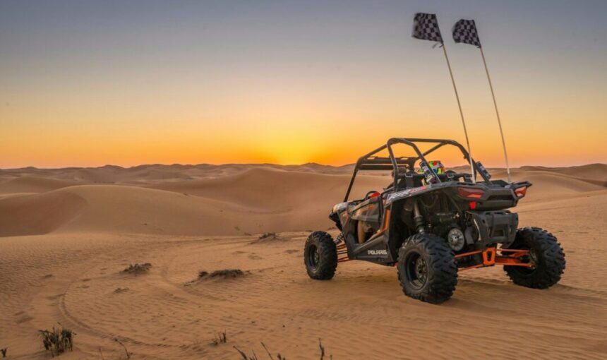 Dubai Dune Buggy Tours: Off-Road Thrills & Easy Booking › Forever Tourism LLC Dubai dune buggy tours with two-seater buggy driving over desert dunes at sunset