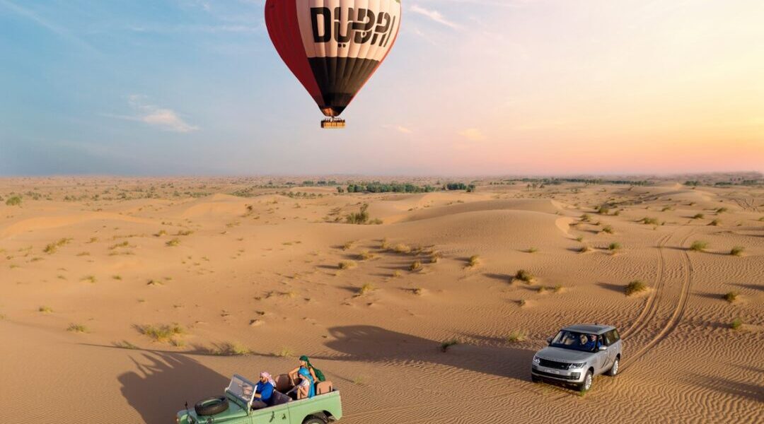 1719299975-Platinum-Heritage-Balloon-And-Land-Rovers-1 › Forever Tourism LLC Dubai Desert Safari package with 4×4 on red dunes, camel ride, and camp lights