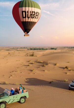 Dubai Desert Safari package with 4×4 on red dunes, camel ride, and camp lights