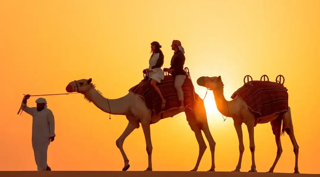 Arabian Safari on red dunes at sunset with 4×4, camel ride, and lantern-lit camp