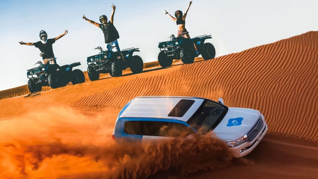 Dubai dune buggy tours with two-seater buggy riding over Dubai desert dunes at sunset