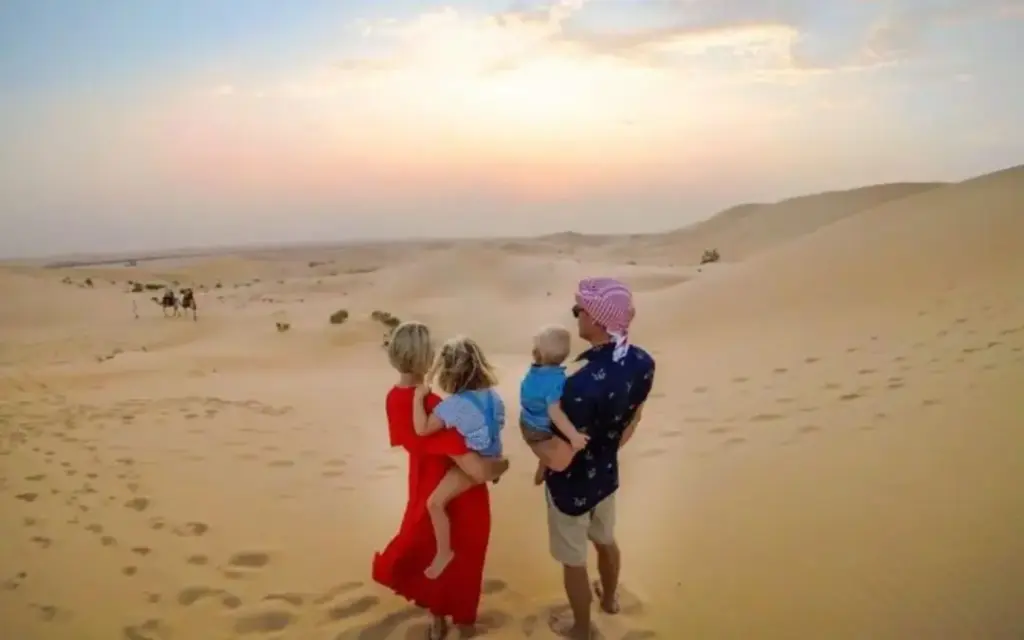 Dubai desert safari without dune bashing featuring camel rides, cultural experiences, and serene views of the Arabian desert at sunset.