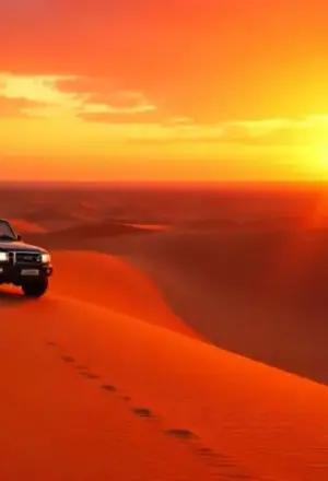 sahara dubai red dunes at sunset with 4x4, camel ride, and camp lights
