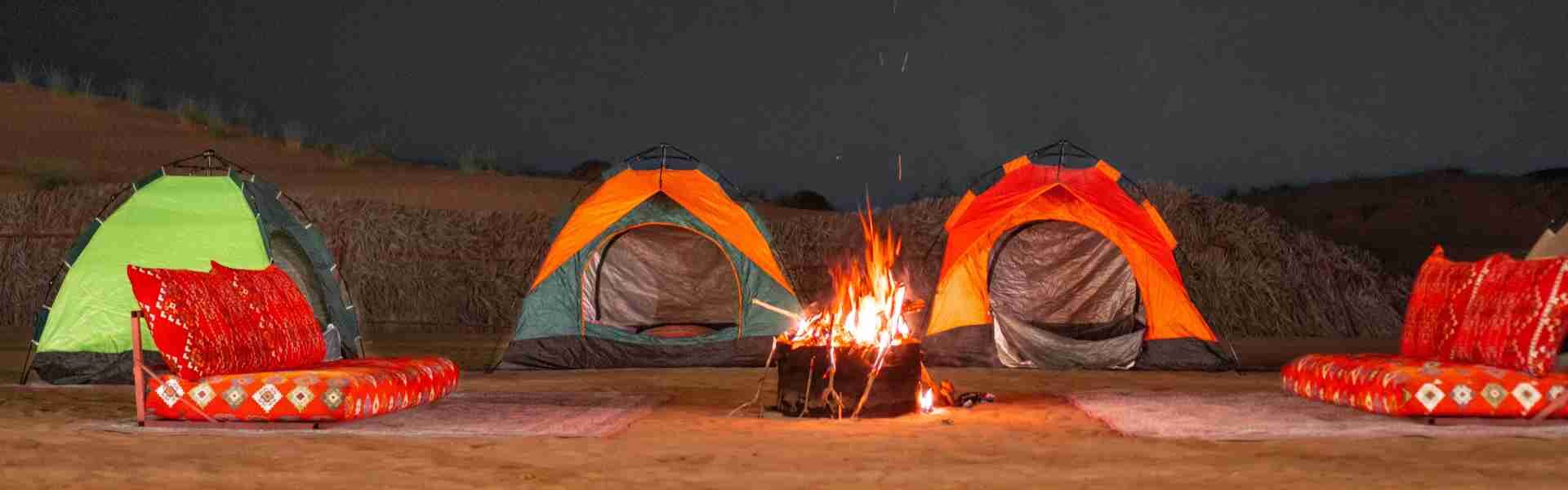 › Forever Tourism LLC overnight camp setup in Dubai desert with tents, lanterns, and starry sky