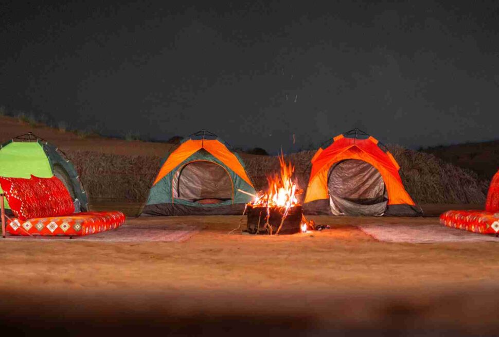 › Forever Tourism LLC overnight camp setup in Dubai desert with tents, lanterns, and starry sky
