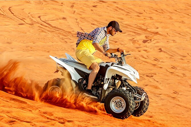 Quad Bike Desert Safari Dubai Adventure Ride › Forever Tourism LLC Adventurer riding a quad bike through golden dunes during Quad Bike Desert Safari Dubai.