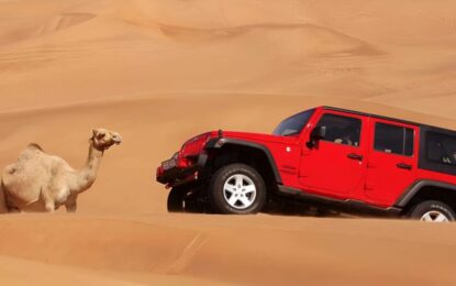 › Forever Tourism LLC jeep safari Dubai 4x4 on red dunes at sunset with riders