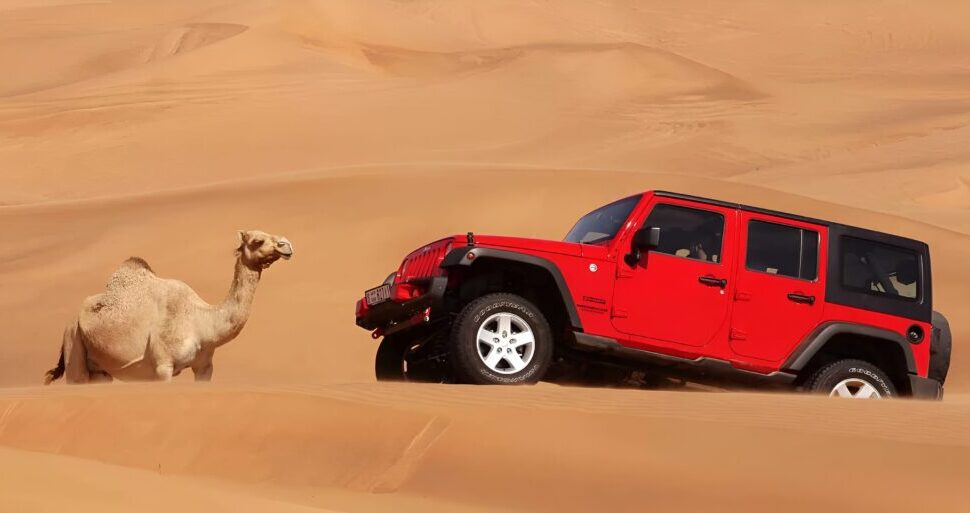 › Forever Tourism LLC jeep safari Dubai 4x4 on red dunes at sunset with riders