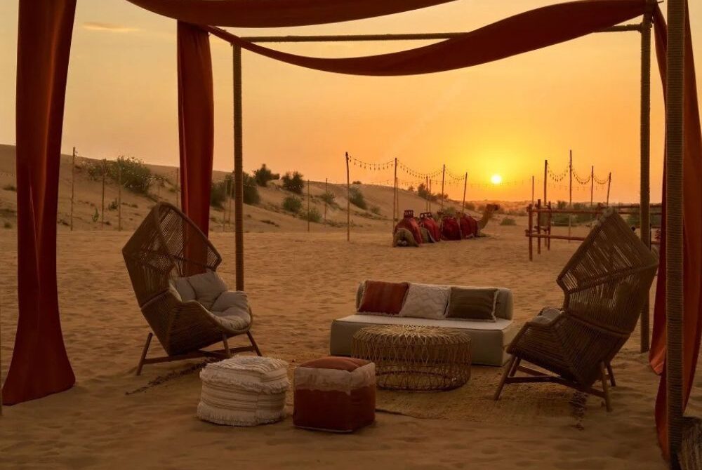 WhatsApp Image 2025-08-28 at 60629 PM › Forever Tourism LLC Cozy lounge seating with traditional décor at Al Khayma Desert Camp Dubai during a stunning desert sunset.