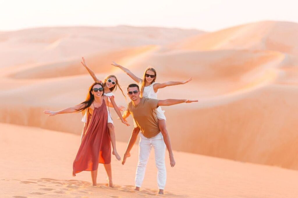 desert safari outfit ideas with breathable layers, hat, scarf, and closed shoes on Dubai dunes