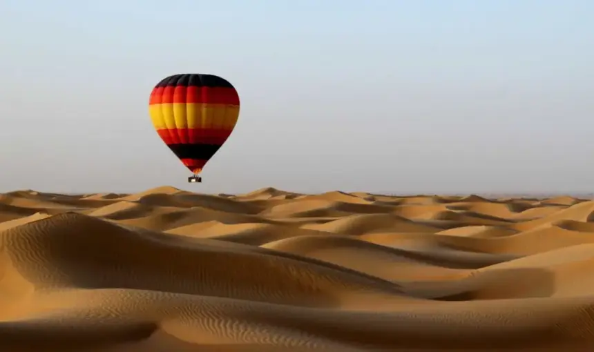 › Forever Tourism LLC Dubai Desert Safari 4×4 on red dunes at sunset with lantern-lit camp