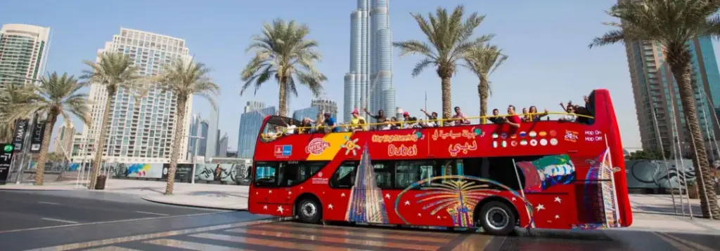 Big Bus Tours Dubai hop-on hop-off bus passing Burj Khalifa and Dubai skyline