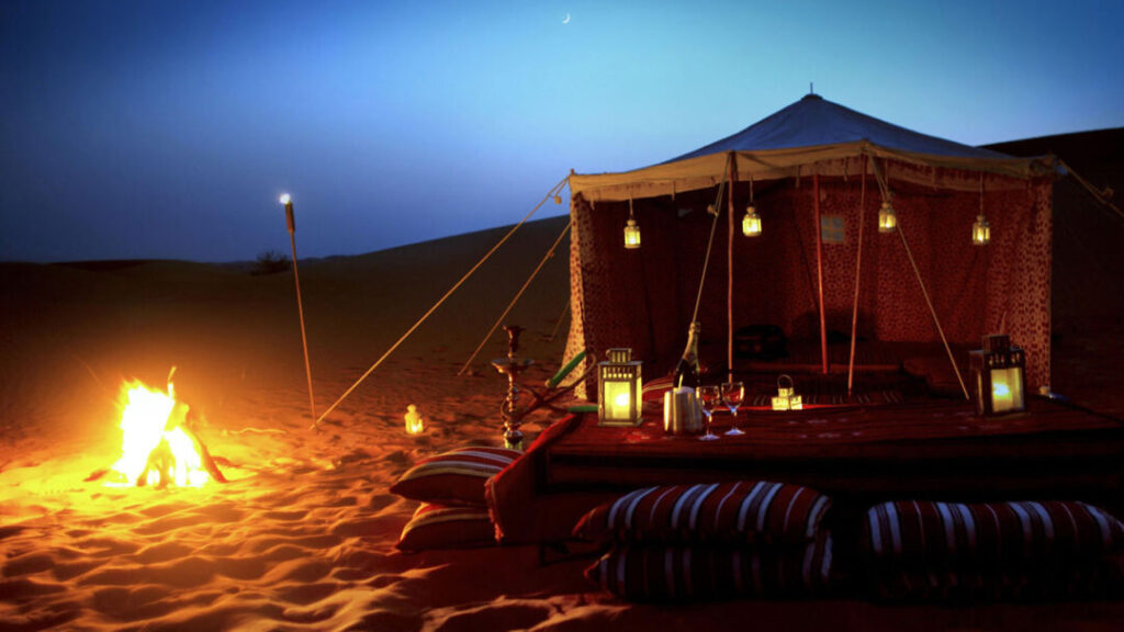 Luxury Desert Camp Night at Lama Desert Safari Dubai › Forever Tourism LLC Luxury tent and bonfire setup at Lama Desert Safari Dubai, offering an authentic Arabian night experience in the desert.