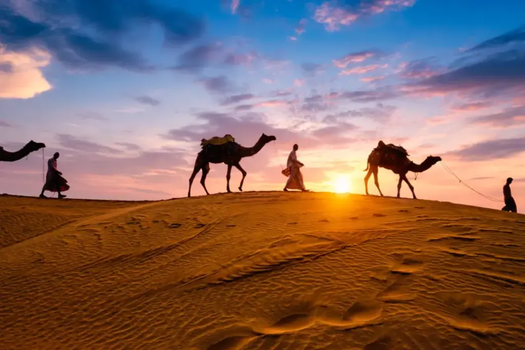 Dubai Desert Safari package with 4×4 on red dunes, camel ride, and camp lights