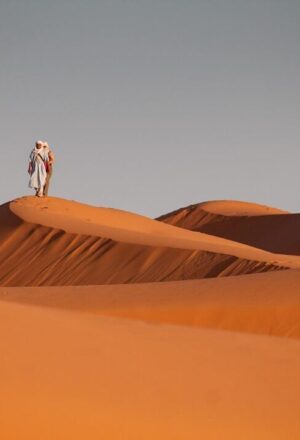 Red Dunes Desert Safari with 4×4 cresting red dunes at sunset and lantern-lit camp