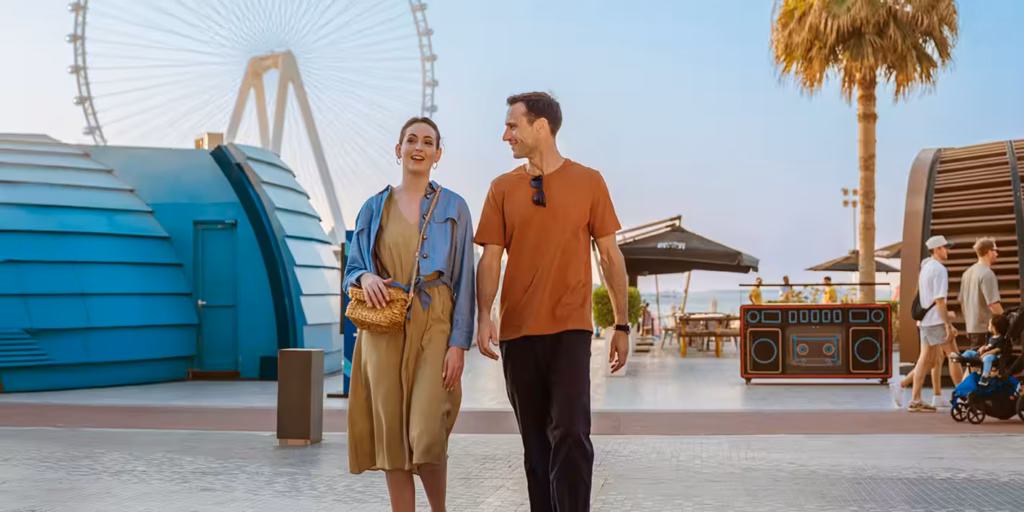 happy family on a package tour holiday with luggage and city and desert in background