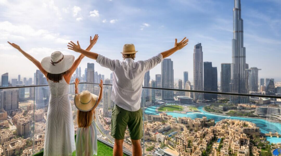 happy family on a package tour holiday with luggage and city and desert in background › Forever Tourism LLC happy family on a package tour holiday with luggage and city and desert in background