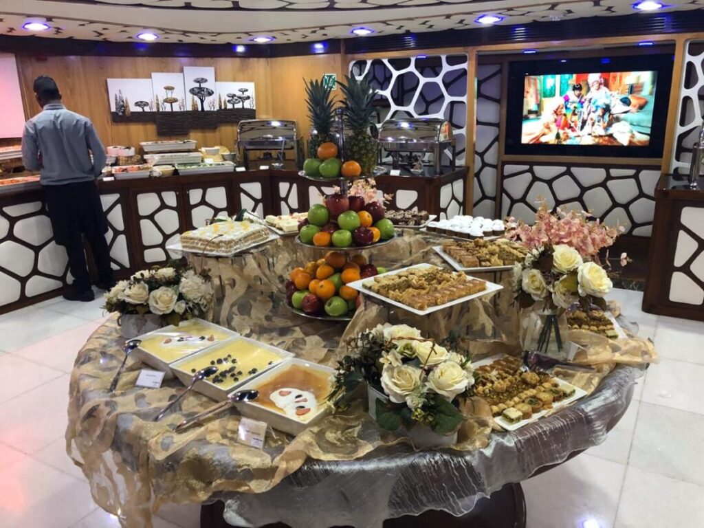 Lotus Cruise Dubai mega yacht dinner with city skyline and guests on deck