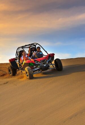 buggy desert safari Dubai with rider speeding across red dunes