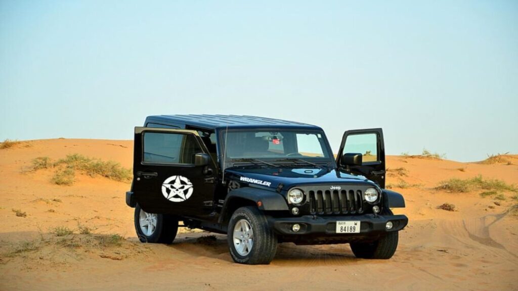 Desert safari self drive experience with a 4x4 Jeep parked on Dubai sand dunes