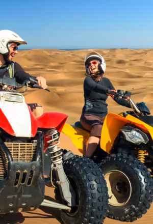ATV desert safari Dubai rider driving quad bike on red dunes
