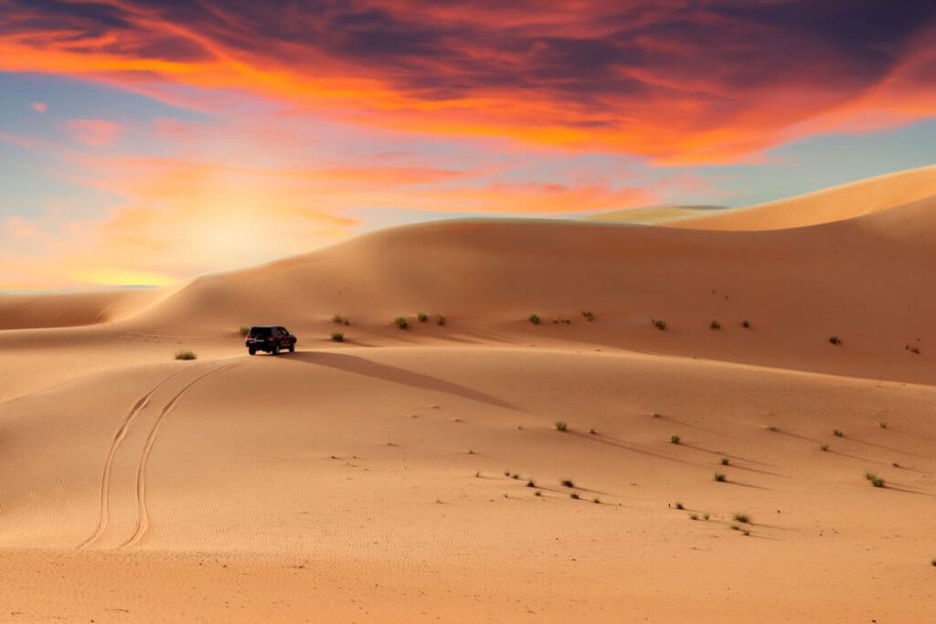 Golden dunes at sunset showcasing desert safari Dubai offers with scenic desert adventure views