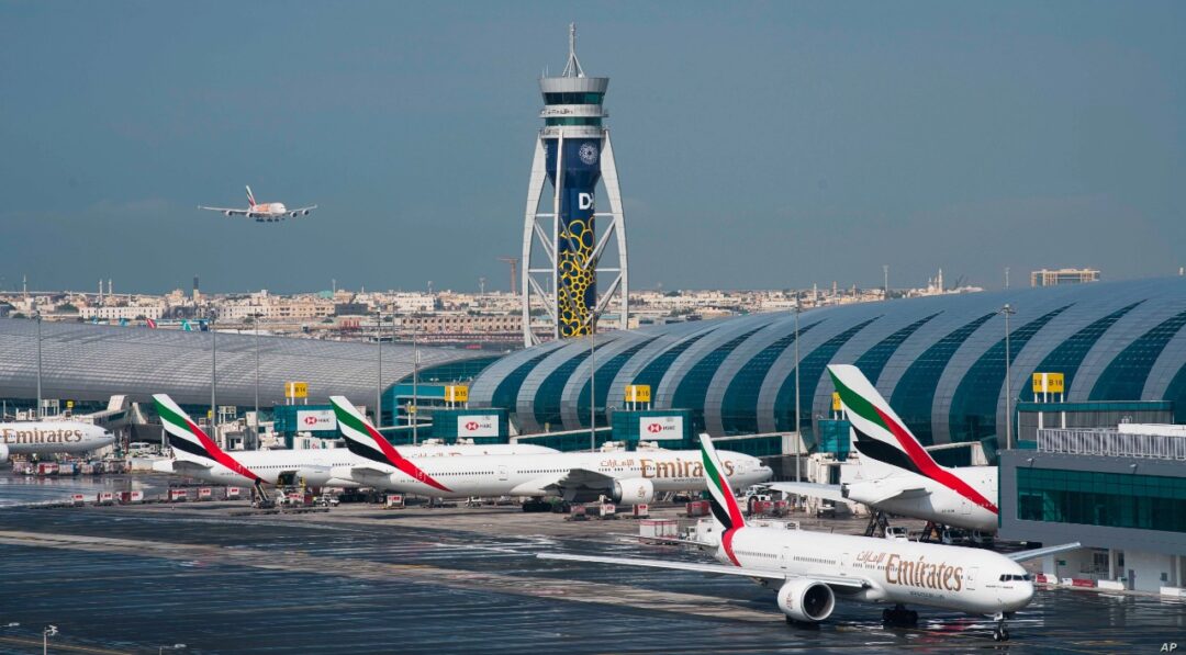 “Dubai Airport with Emirates aircraft parked at Dubai International Airport terminals”