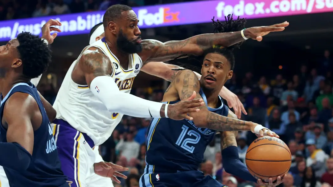 “Lakers vs Grizzlies NBA game showing LeBron James defending Ja Morant during live action”