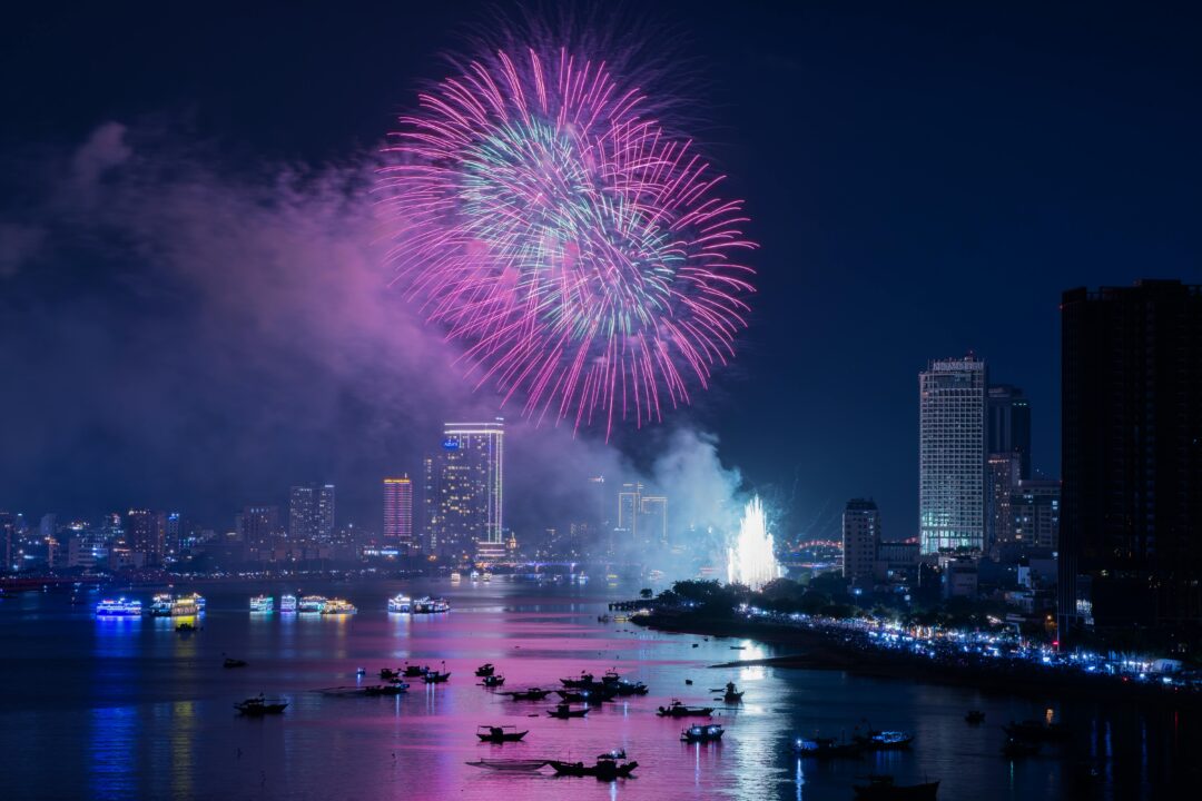 Upcoming Dubai events showcased by vibrant fireworks lighting up the Dubai skyline at night with waterfront reflections and illuminated skyscrapers