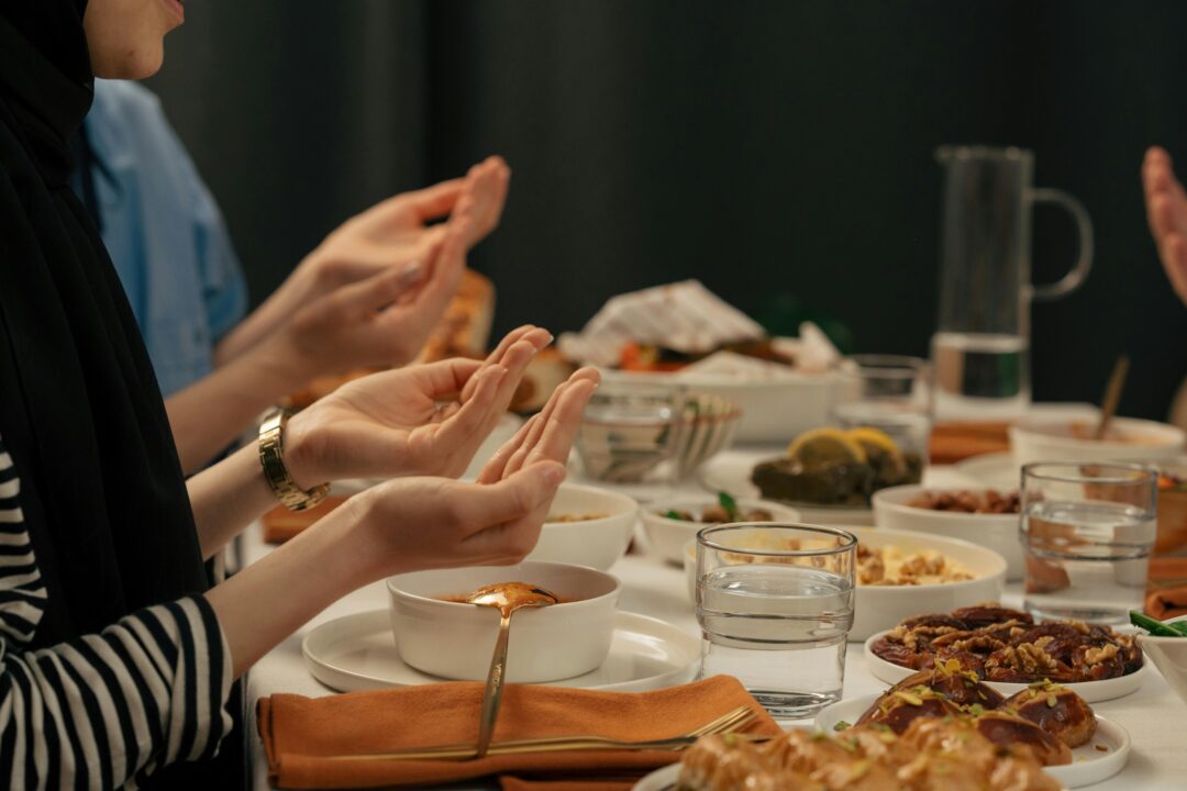 People praying before breaking their fast at a free iftar meal in Dubai during Ramadan