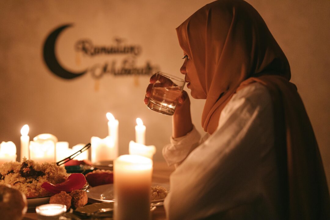 Can You Eat in Hotels in Dubai During Ramadan? 2026 guide › Forever Tourism LLC Woman breaking her fast with water at iftar during Ramadan in Dubai hotel setting